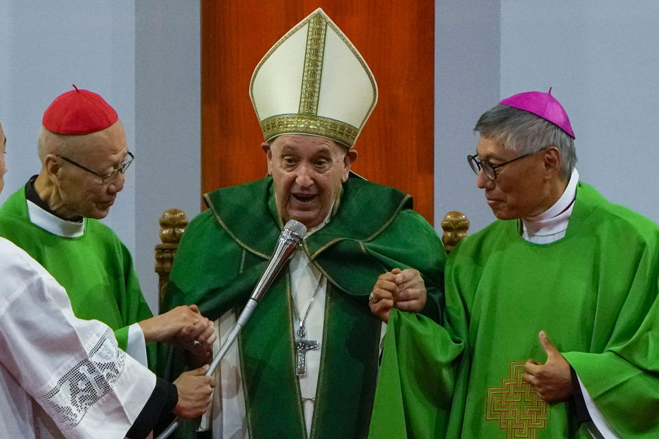 Pope Francis is joined by Cardinal John Tong Hon, left, and Cardinal-elect Stephen Chow, both from Hong Kong, after presiding over a mass at the Steppe Arena in the Mongolian capital Ulaanbaatar, Sunday, Sept. 3, 2023. Francis is in Mongolia to minister to one of the world's smallest and newest Catholic communities. Neighboring China's crackdown on religious minorities has been a constant backdrop to the trip, even as the Vatican hopes to focus attention instead on Mongolia and its 1,450 Catholics. (AP Photo/Ng Han Guan)