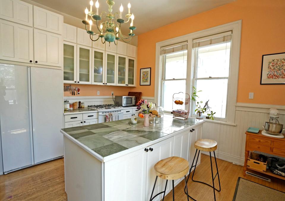 An island with marble tiles is seen in the kitchen of homeowners Rebekah and James Nicholas. Their home is part of the 2023 Historic Concordia Home Tour in Milwaukee.