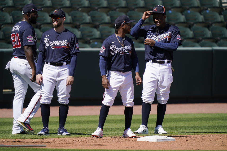 Atlanta Braves' from left, Marcell Ozuna, Ender Inciarte, Ozzie Albies, and Ronald Acuna Jr. wait to run bases during spring training baseball practice on Tuesday, Feb. 23, 2021, in North Port, Fla. (AP Photo/Brynn Anderson)