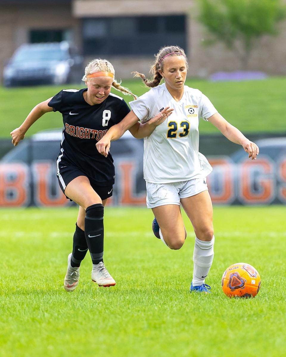 Hartland's Alyse Daavettila (23), defended by Brighton's Ainsley Seiter (8), is one of two remaining Eagles who played during the 2021 state championship run.