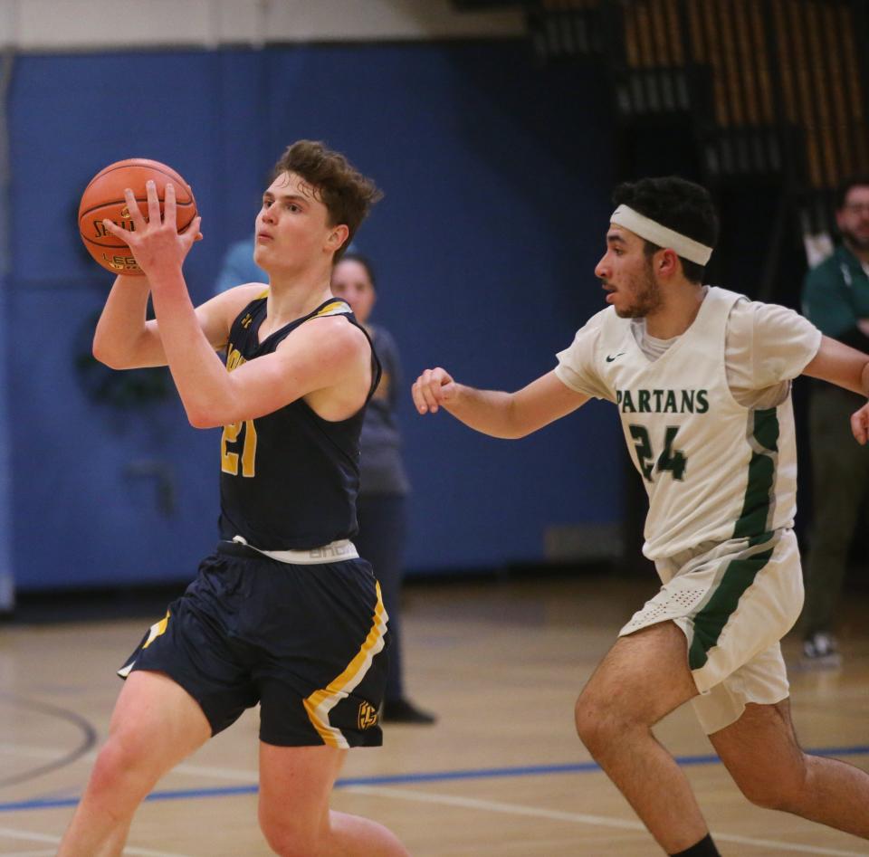 Lourdes' Patrick Faughnan goes for a layup against Spackenkill's Sanad Sahawneh during the MHAL boys basketball final on February 23, 2023. 