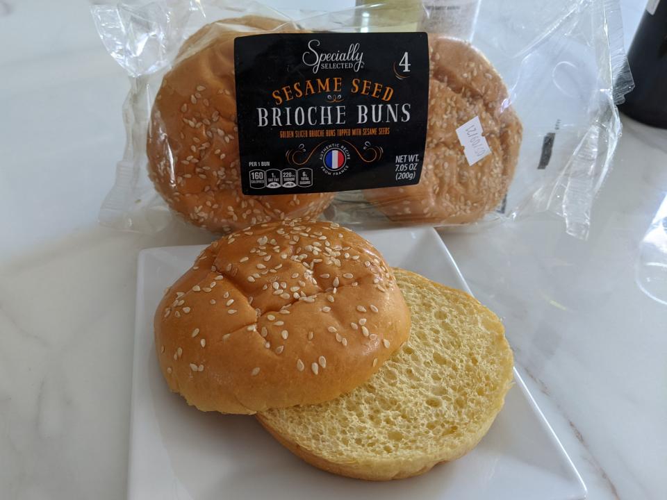 Aldi's specially selected buns in the clear plastic packaging and placed on a white plate