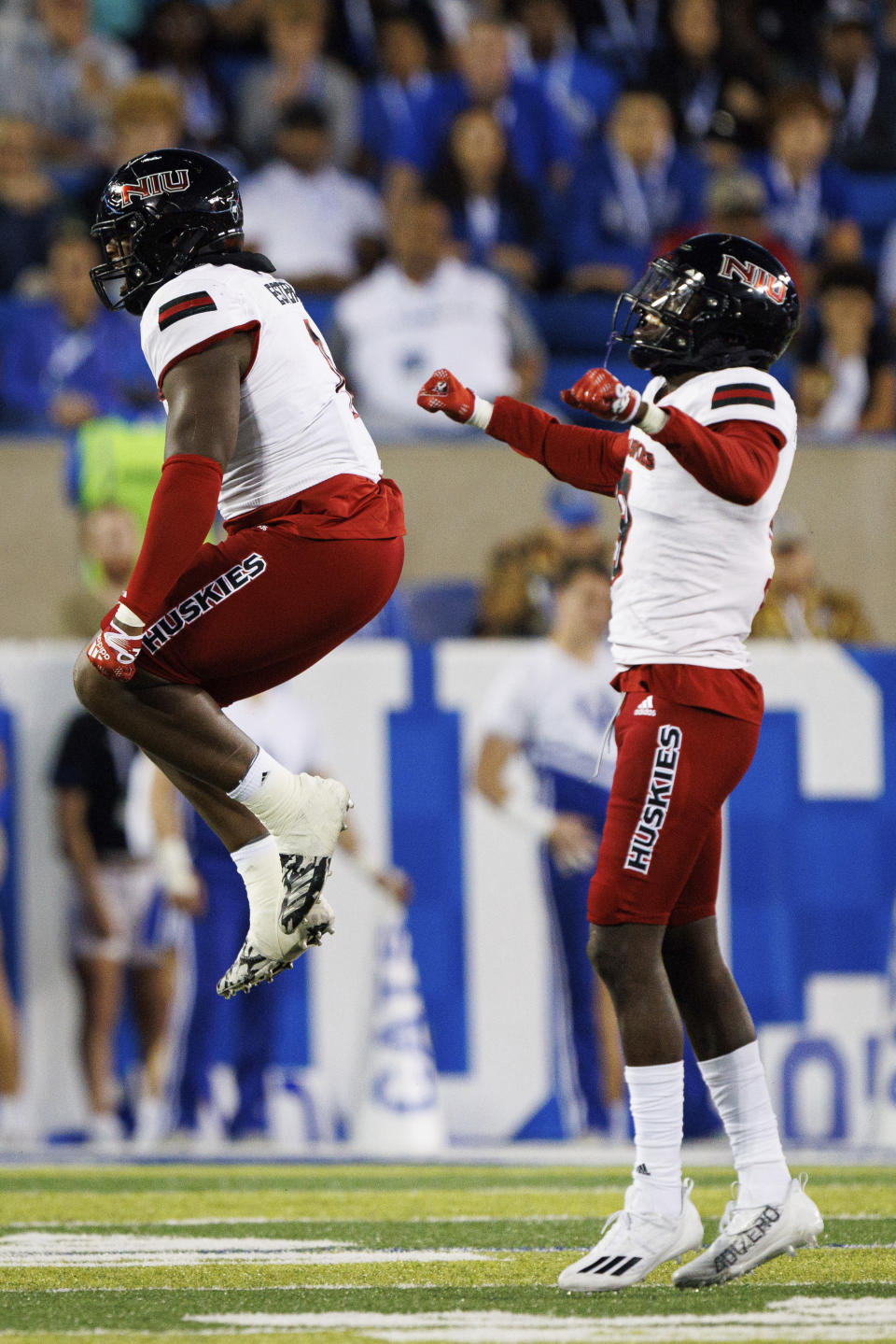 Northern Illinois defensive tackle Devonte O'Malley, left, celebrates after getting a sack during the first half of an NCAA college football game against Kentucky in Lexington, Ky., Saturday, Sept. 24, 2022. (AP Photo/Michael Clubb)