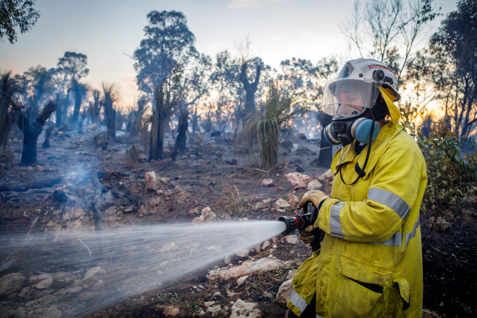 Firefighters are seen battling a bushfire in Yanchep, Western Australia. Source: AAP