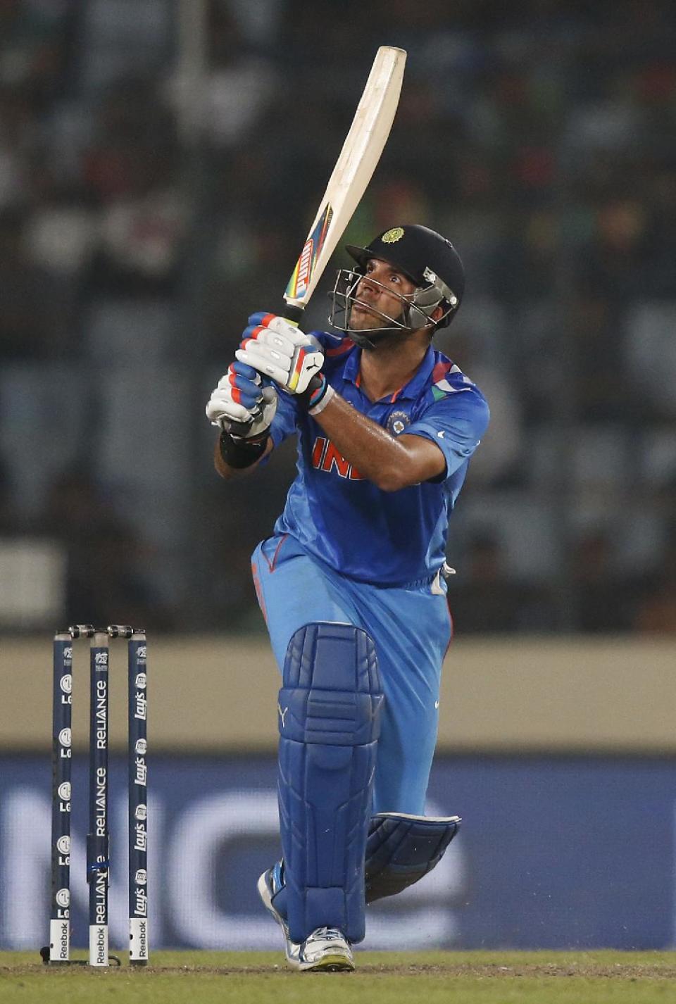 India's batsman Yuvraj Singh watches his shot during their ICC Twenty20 Cricket World Cup match against Australia in Dhaka, Bangladesh, Sunday, March 30, 2014. (AP Photo/Aijaz Rahi)