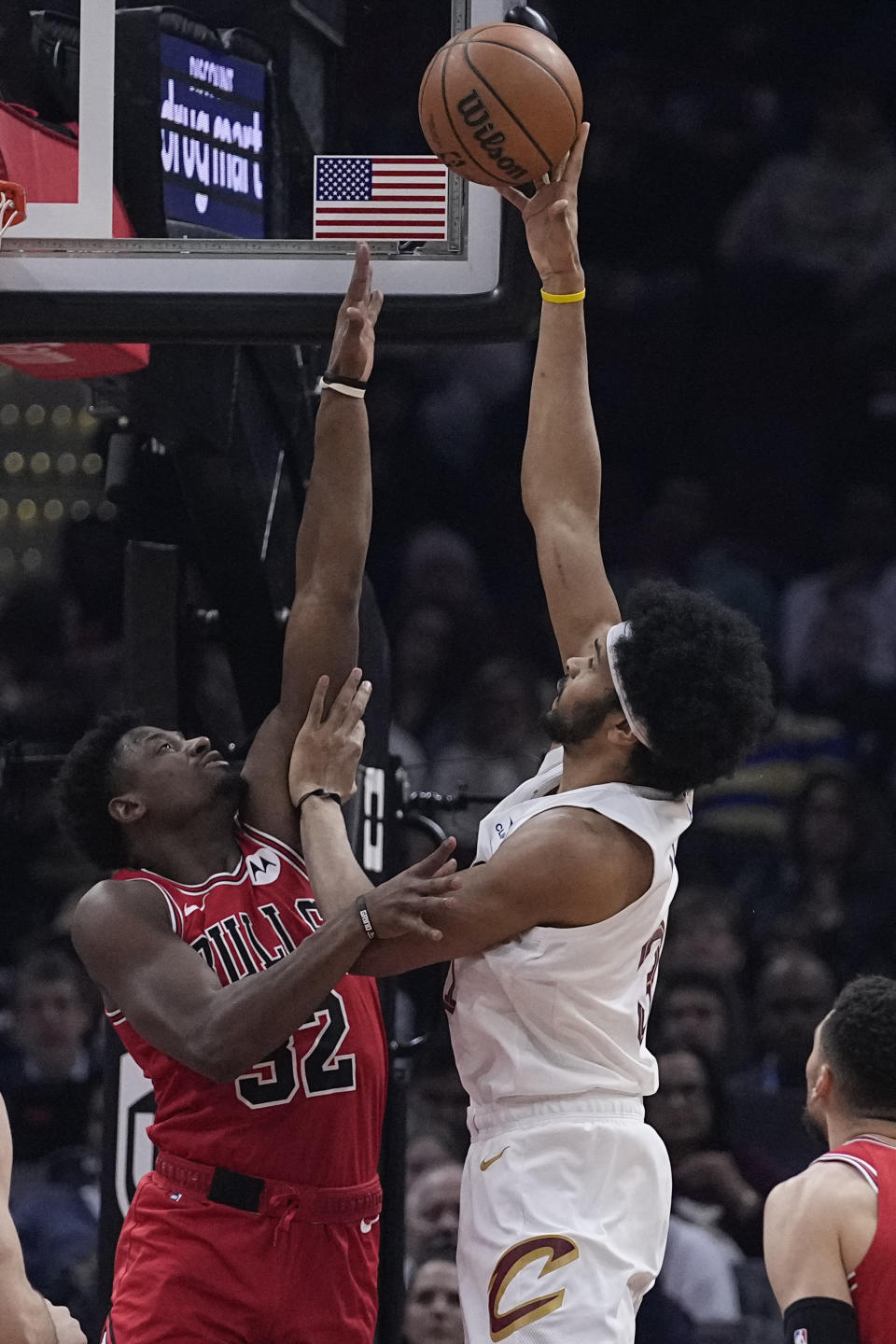 Cleveland Cavaliers center Jarrett Allen, right, shoots over Chicago Bulls forward Terry Taylor, left, in the first half of an NBA basketball game, Monday, Jan. 15, 2024, in Cleveland. (AP Photo/Sue Ogrocki)