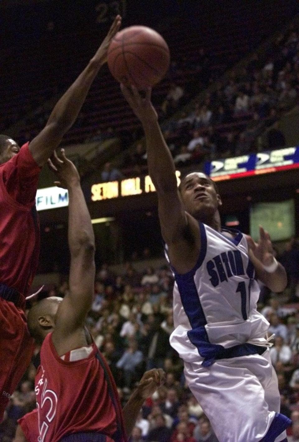 In 2000, Seton Hall point guard Shaheen Holloway goes to the hoop in front of St. John's Anthony Glover and Lavor Postell.