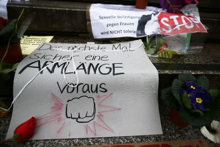 Flowers and posters are placed in the square between the city cathedral and the railway station in Cologne, Germany, January 11, 2016, where the vast majority of dozens of New Year Eve assaults on women took place. The texts read 'Sexual harassement against women will be NOT tolerated' and 'Next time for sure an arm length in advance'. REUTERS/Wolfgang Rattay