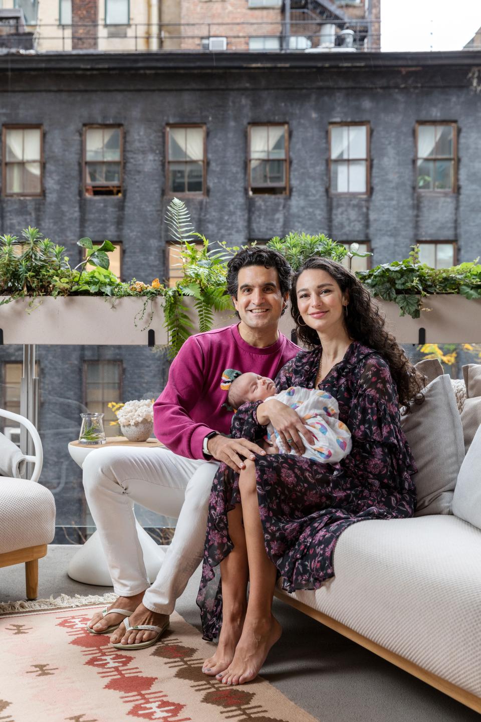 On the deck of their Great Jones apartment, Bonobos founder Andy Dunn, his wife Manuela Zoninsein, and their first child, Izzo, sit on a Gloster sofa that features a eucalyptus wood frame. The family-owned outdoor furniture company is dedicated to ethically sourced materials and sustainability. (For every eucalyptus tree the brand cuts down to hand-craft their designs it plants two more.) The end table behind Dunn is also by Gloster.