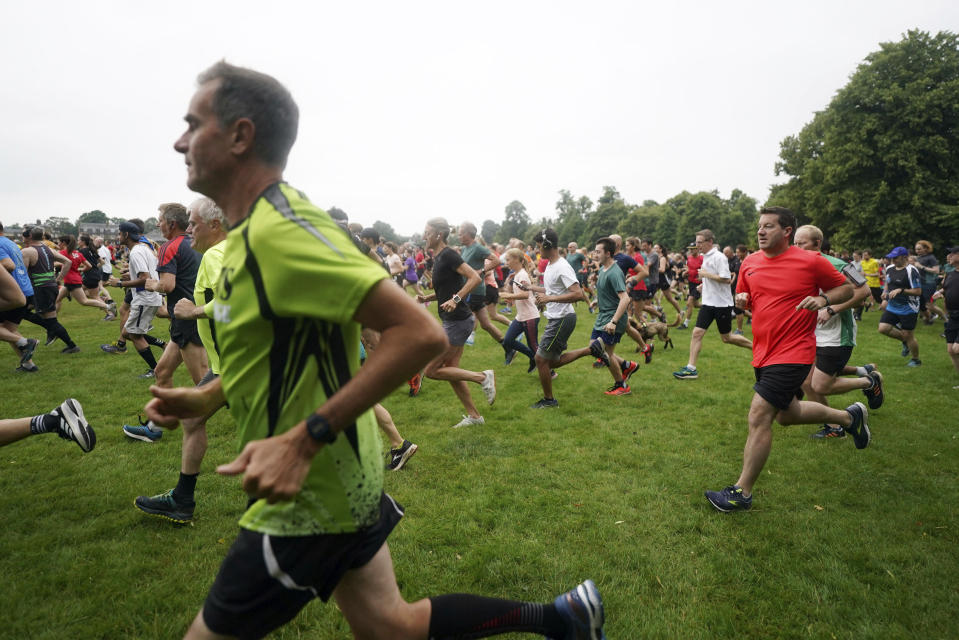 People take part in the Park Run at Bushy Park in London, Saturday July 24, 2021, one of many runs taking place across the country for the first time since March 2020 when the event was closed due to the COVID-19 pandemic. (Victoria Jones/PA via AP)