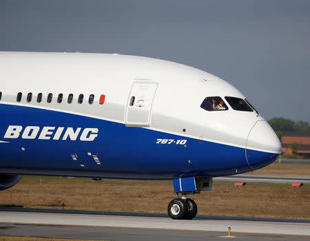 A pilot waves to the crowd during the first flight ceremony of the new Boeing 787-10 Dreamliner at the Charleston International Airport in North Charleston, South Carolina, United States March 31, 2017. REUTERS/Randall Hill