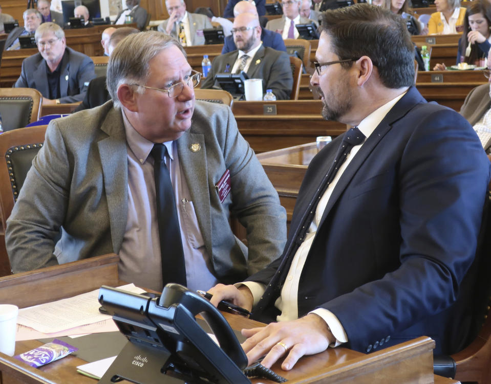 Kansas House Majority Leader Dan Hawkins, left, R-Wichita, confers with House Speaker Ron Ryckman Jr., R-Olathe, during a debate on a proposed $18.4 billion state budget at the Statehouse Friday, May 3, 2019, in Topeka, Kan. The House has rejected the spending plan because Democrats and moderate Republicans wanted to block it in hopes of forcing a debate on Medicaid expansion. (AP Photo/John Hanna)