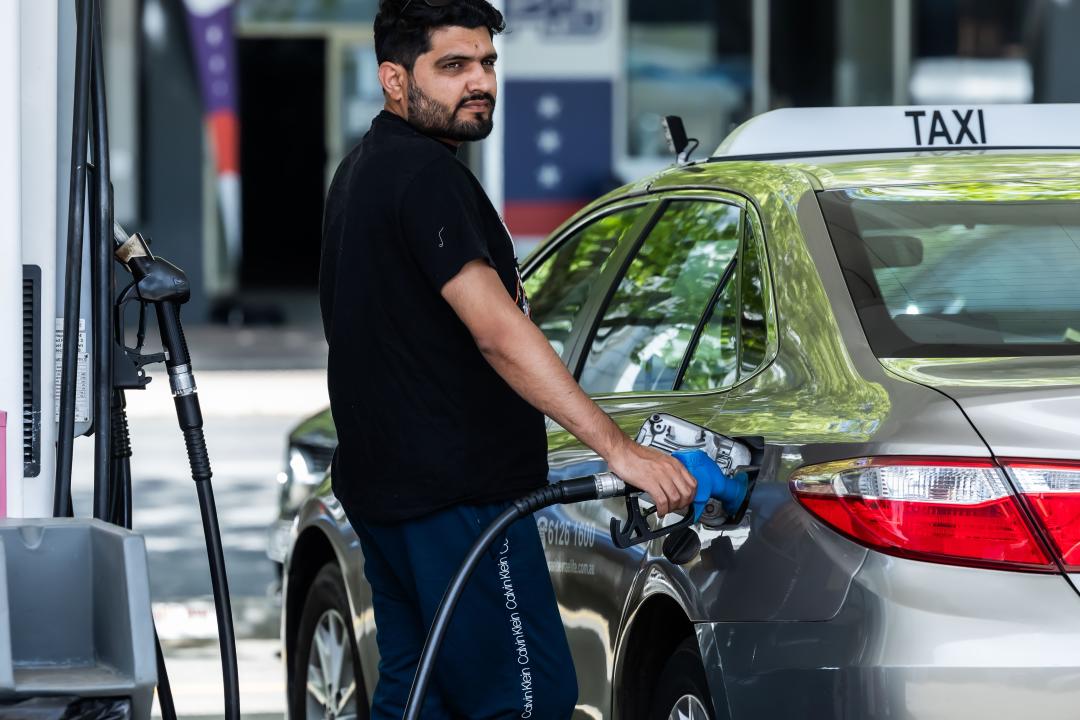 A taxi driver fuels his car at a petrol station in Canberra, Australia, Oct. 23, 2023.  According to estimates released by the Australian Treasury on Monday, consumer price index CPI data for the third quarter of 2023 will show petrol prices in Australia rose by 7 percent between the start of July and the end of September. (Photo by Chu Chen/Xinhua via Getty Images)