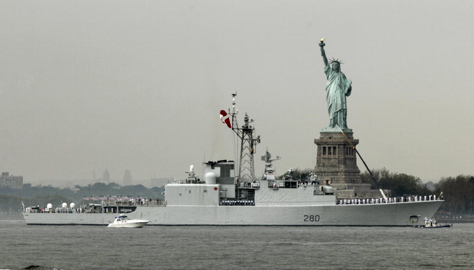 The HMCS Iroquois, from Canada, sails by the Statue Of Liberty, in New York, to participate in Fleet Week activities, Wednesday, May 23, 2012. (AP Photo/Richard Drew)