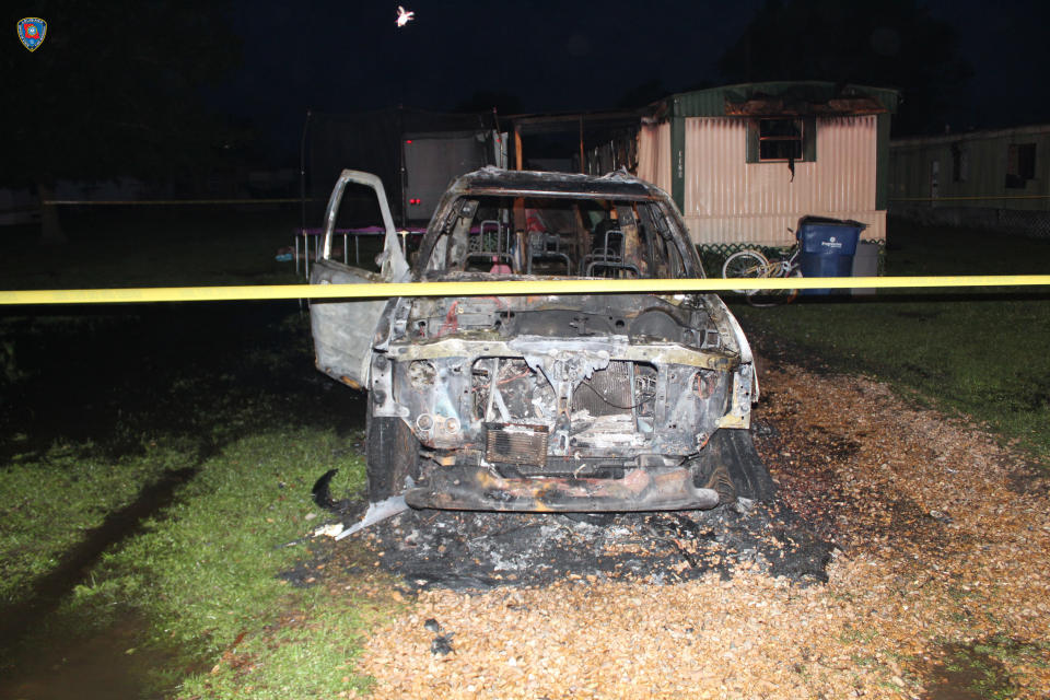 This photo provided by Louisiana State Fire Marshal’s Office shows an automobile that was set on fire in Mamou, La. The Louisiana State Fire Marshal’s Office says a man wearing nothing below the waist has been arrested and accused of setting fire to a mobile home occupied by a woman, a baby and two other children. The fire marshal's office says 33-year-old James Rozas of Mamou was arrested Friday, April 9, 2021 on charges of arson, attempted murder and violating a protective order after the pre-dawn fire. (Louisiana State Fire Marshal’s Office via AP)