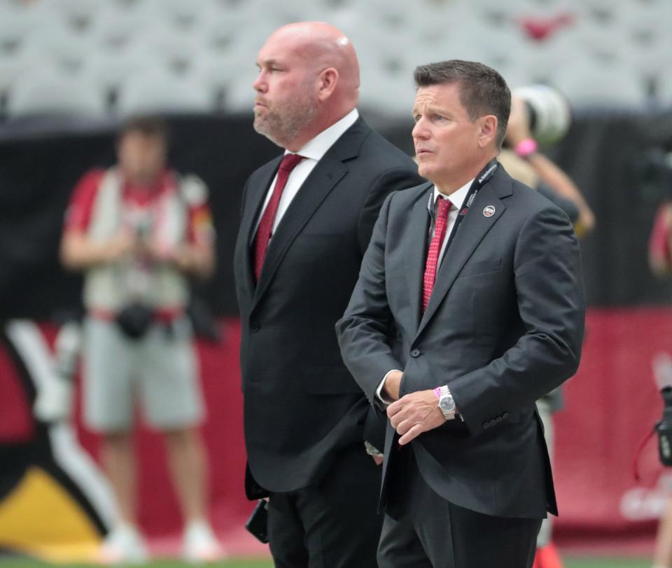 Arizona Cardinals general manager Steve Keim (left) and owner Michael Bidwill watch pre-game warmups before playing against the San Francisco 49ers at State Farm Stadium in Glendale on Oct. 10, 2021.