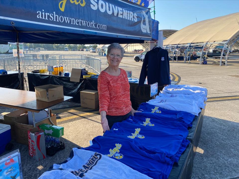 Blue Angels Souvenirs team volunteer and member of the charitable organization Daughters of the Nile, Christine Francis, stands ready at the souvenir booth just before the gates to the Blue Angels 2022 Homecoming Air Show officially open on Saturday, Nov. 12, 2022.