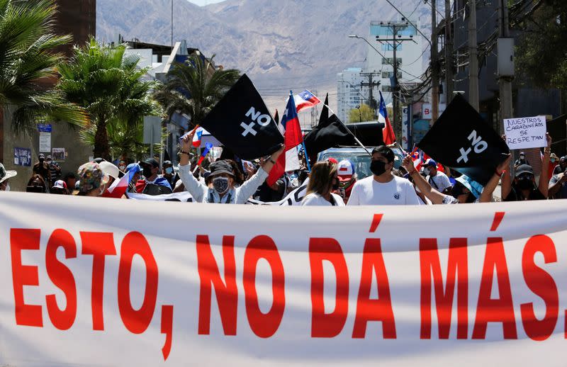 Chileans take part in a rally against migrants and delinquency in Iquique