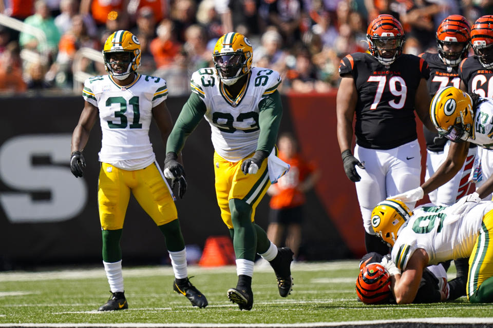 Green Bay Packers defensive tackle T.J. Slaton (93) celebrates a sack against the Cincinnati Bengals in the first half of an NFL football game in Cincinnati, Sunday, Oct. 10, 2021. (AP Photo/Bryan Woolston)