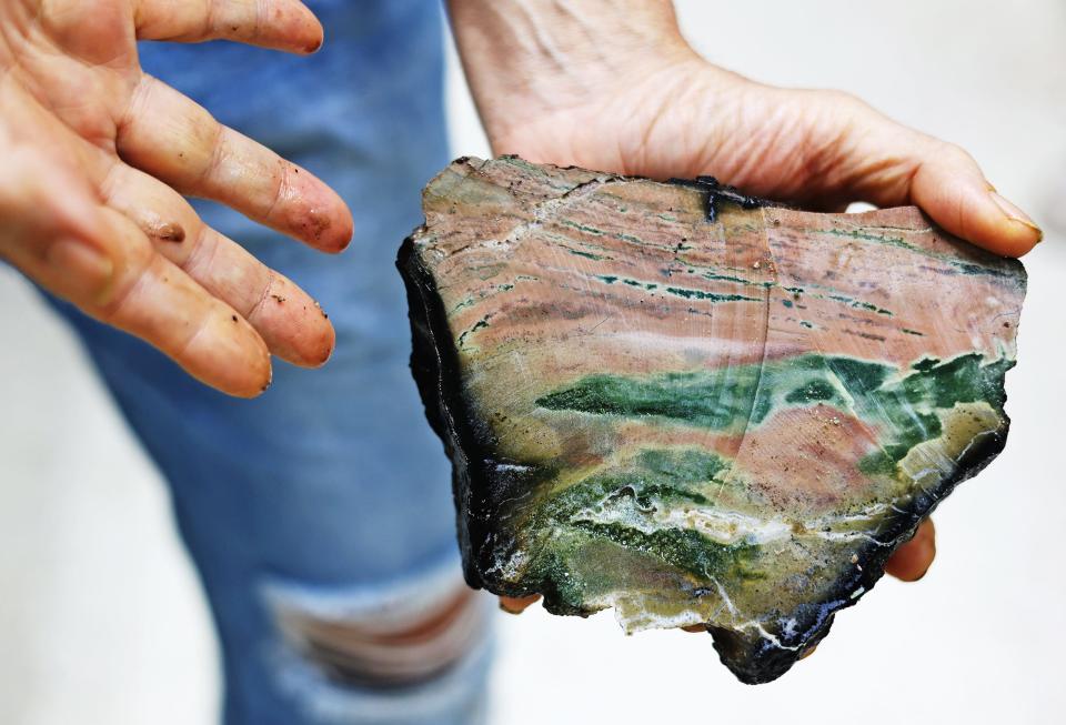 Geologist Ken Rubin holds a fragment of the North American continental plate collected by Alvin during a dive this summer in the Puerto Rico Trench. Rubin estimates this section is approximately 100 million years old.