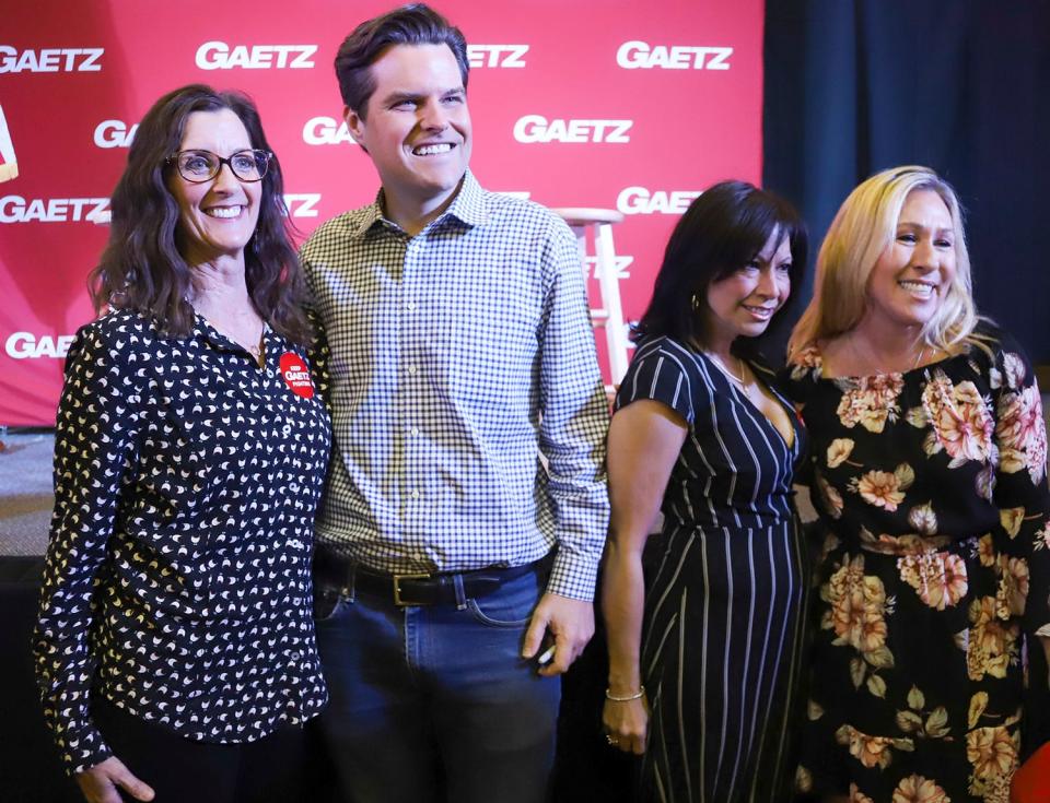 U.S. Reps. Matt Gaetz, of Florida, and Marjorie Taylor Greene, of Georgia, pose for photos with supporters at a campaign stop for Gaetz in Crestview on Saturday.