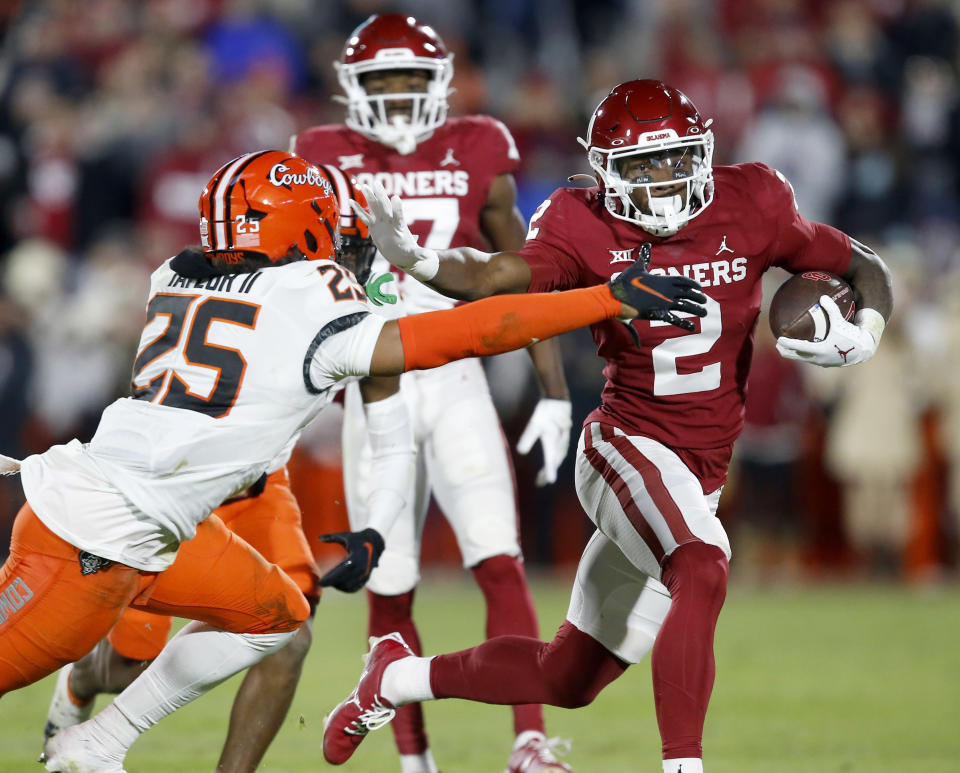Nov. 19, 2022; Norman; Oklahoma Sooners running back Jovantae Barnes (2) runs the ball against Oklahoma State Cowboys safety <a class="link " href="https://sports.yahoo.com/nfl/players/40287" data-i13n="sec:content-canvas;subsec:anchor_text;elm:context_link" data-ylk="slk:Jason Taylor II;sec:content-canvas;subsec:anchor_text;elm:context_link;itc:0">Jason Taylor II</a> (25) in the second quarter at Gaylord Family-Oklahoma Memorial Stadium. Sarah Phipps-USA TODAY Sports
