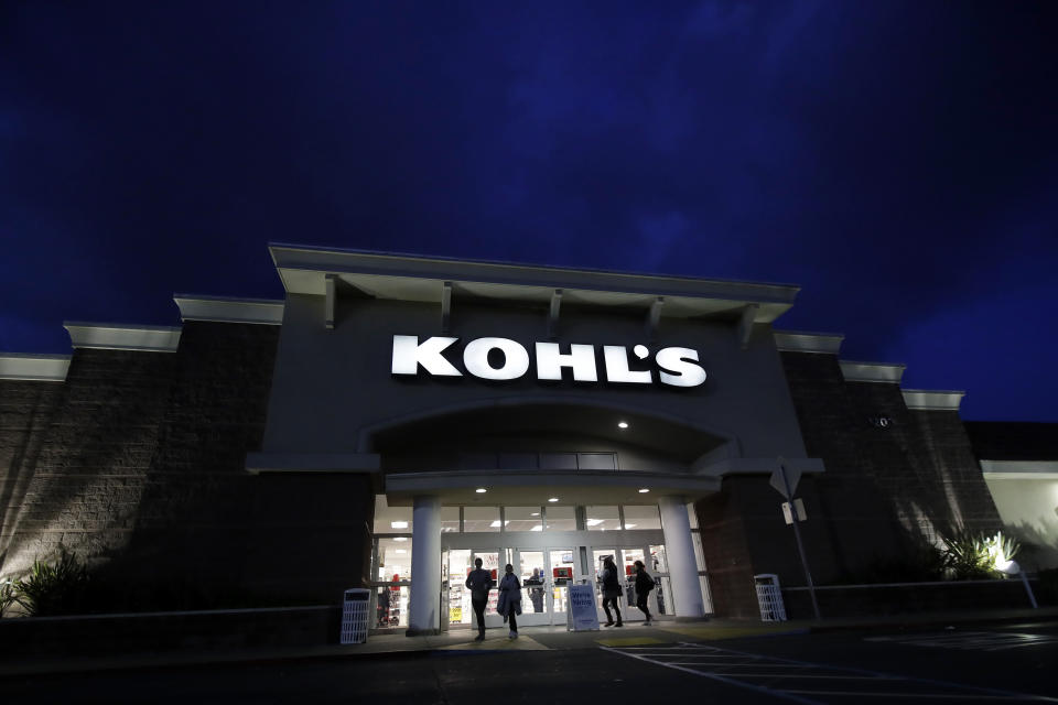 FILE - In this Nov. 29, 2019, file photo, customers walk outside of a Kohl's store in Colma, Calif. Macy's, Kohl's and Gap Inc. all said Monday, March 30, 2020, they will stop paying tens of thousands of employees who were thrown out of work when the chains temporarily closed their stores and sales collapsed as a result of the pandemic. (AP Photo/Jeff Chiu, File)