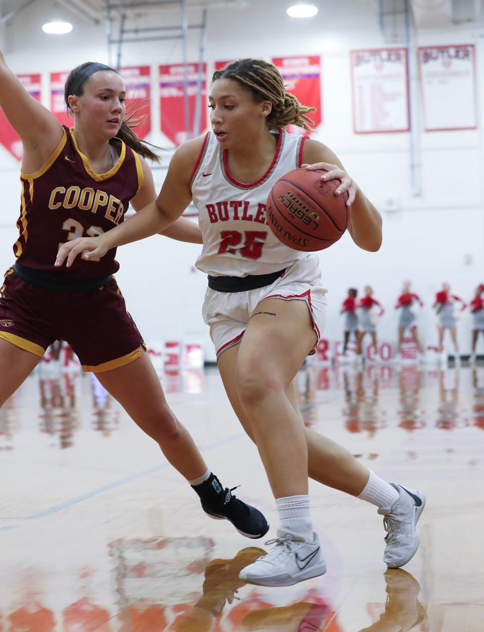 Butler's Mariah Knight	(25) drives against Cooper 's Liz Freihofer (32) during their game at Buter High School in Louisville, Ky. on Nov. 28, 2023.