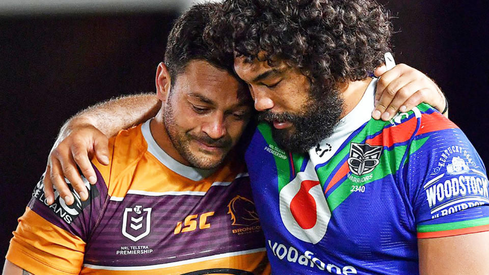 Brisbane Broncos captain Alex Glenn is pictured being consoled after the game by a New Zealand Warriors opponent.