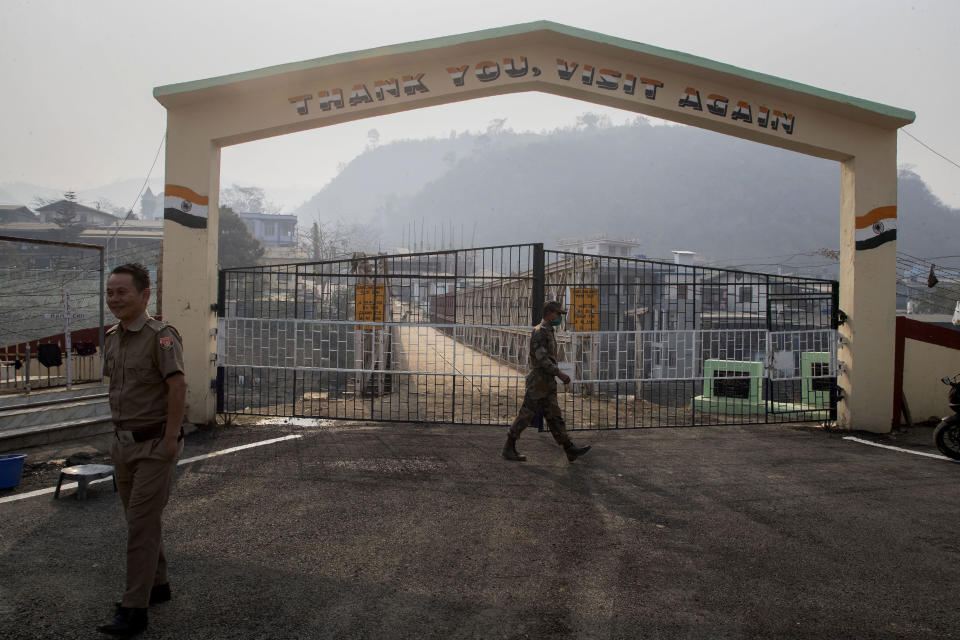 An Indian army soldier, center, and a Mizo policeman patrol at the India-Myanmar border gate , in Chaamphai village, in Mizoram, India, Saturday, March 20, 2021. Several Myanmar police officers who fled to India after defying army orders to shoot opponents of last month’s coup are urging Prime Minister Narendra Modi’s government to not repatriate them and provide them political asylum on humanitarian grounds.(AP Photo/Anupam Nath)