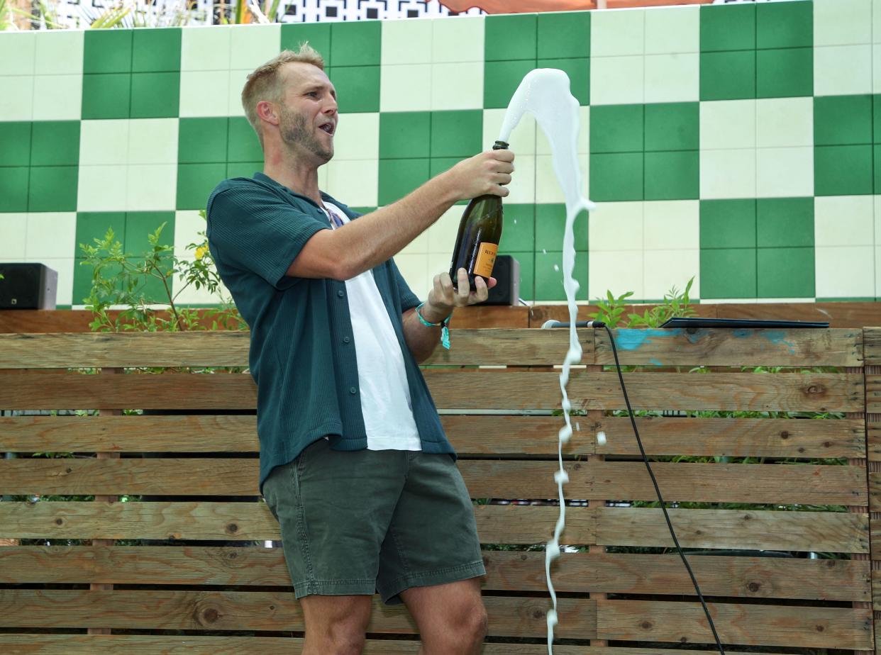 Splash House founder Tyler McLean pops the champagne during an event commemerating the festival's 10-year anniversary at the Renaissance Palm Springs Hotel, August 11, 2023 in Palm Springs Calif.