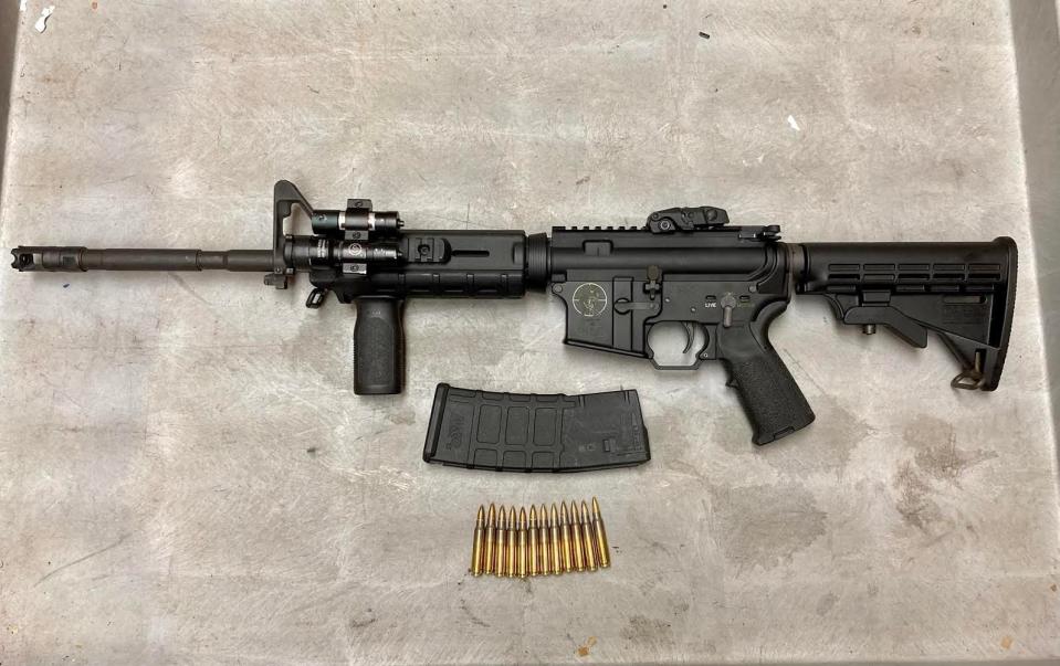Police display a Spikes Tactical Zombie SL15 rifle seized after a July 3 shooting in Hillcrest Apartments.