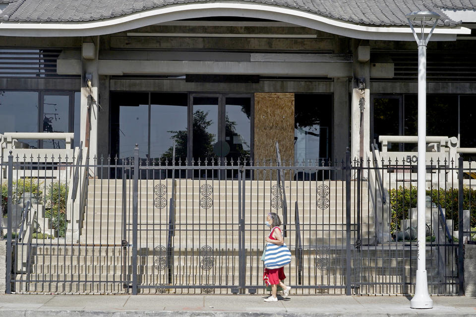 Image: A pedestrian walks past the closed Higashi Honganji Buddhist Temple in Los Angeles, on Feb. 27, 2021. (Damian Dovarganes / AP)