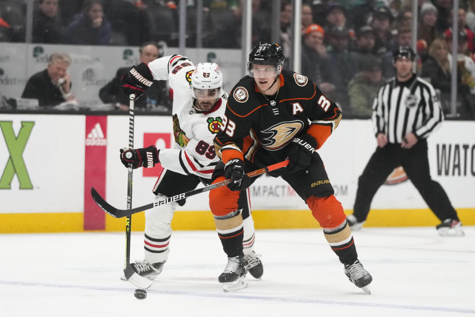 Anaheim Ducks' Jakob Silfverberg (33) moves the puck against Chicago Blackhawks' Andreas Athanasiou (89) during the first period of an NHL hockey game Monday, Feb. 27, 2023, in Anaheim, Calif. (AP Photo/Jae C. Hong)