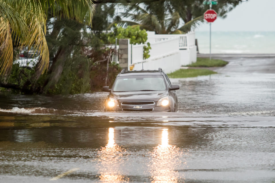 A car drives through a flooded street after the effects of Hurricane Dorian in Nassau, Bahamas.