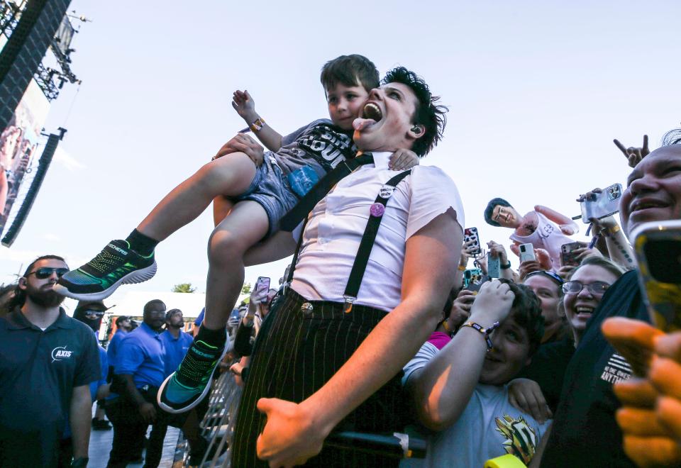 British rocker Yungblud swings 4-year-old Cody Weiss on the first day of Louder Than Life in 2022.