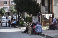 People sit and stand on the streets after evacuating their homes, following an earthquake in Istanbul, Thursday, Sept. 26, 2019. Turkey's emergency authority says a 5.8 magnitude earthquake has shaken Istanbul with no immediate damage reported. (DHA via AP)