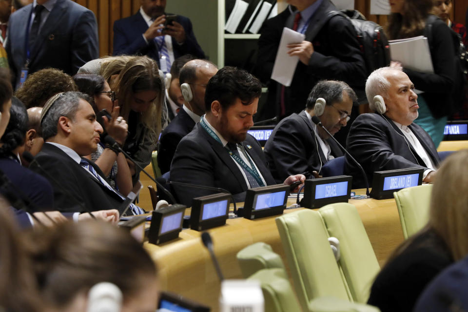 Israel's Minister of Environmental Protection Ze'ev Elkin, left, and Iran's Foreign Minister Javad Zarif, right, listen to speeches during the High Level Political Forum on Sustainable Development, at United Nations headquarters, Wednesday, July 17, 2019. (AP Photo/Richard Drew)