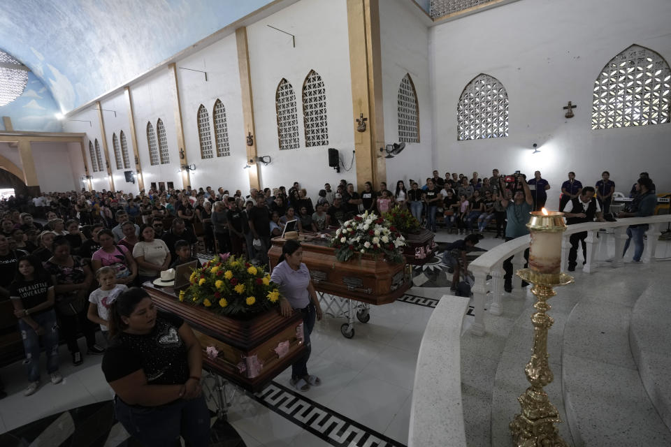 CORRECTS DATE ACTIVIST WAS KILLED - Mourners attend a funeral Mass for armed civilian defense leader Hipolito Mora and two of his bodyguards at his home in La Ruana, Mexico, Saturday, July 1, 2023. Mora, the leader of an armed civilian movement that once drove a drug cartel out of the western state of Michoacan, was killed on June 29th on a street in his hometown. (AP Photo/Eduardo Verdugo)