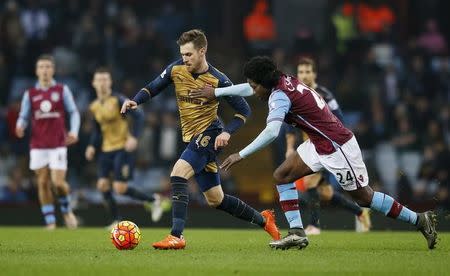 Football Soccer - Aston Villa v Arsenal - Barclays Premier League - Villa Park - 13/12/15 Arsenal's Aaron Ramsey in action with Aston Villa's Carlos Sanchez Action Images via Reuters / Paul Childs Livepic