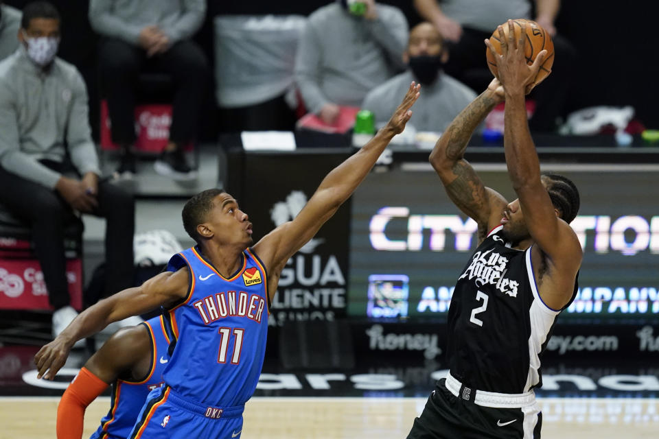 Oklahoma City Thunder guard Theo Maledon (11) defends against Los Angeles Clippers forward Kawhi Leonard (2) during the first quarter of an NBA basketball game Sunday, Jan. 24, 2021, in Los Angeles. (AP Photo/Ashley Landis)