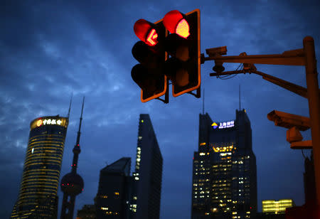 Traffic lights are seen at the Pudong financial district in Shanghai August 11, 2014. REUTERS/Carlos Barria/Files