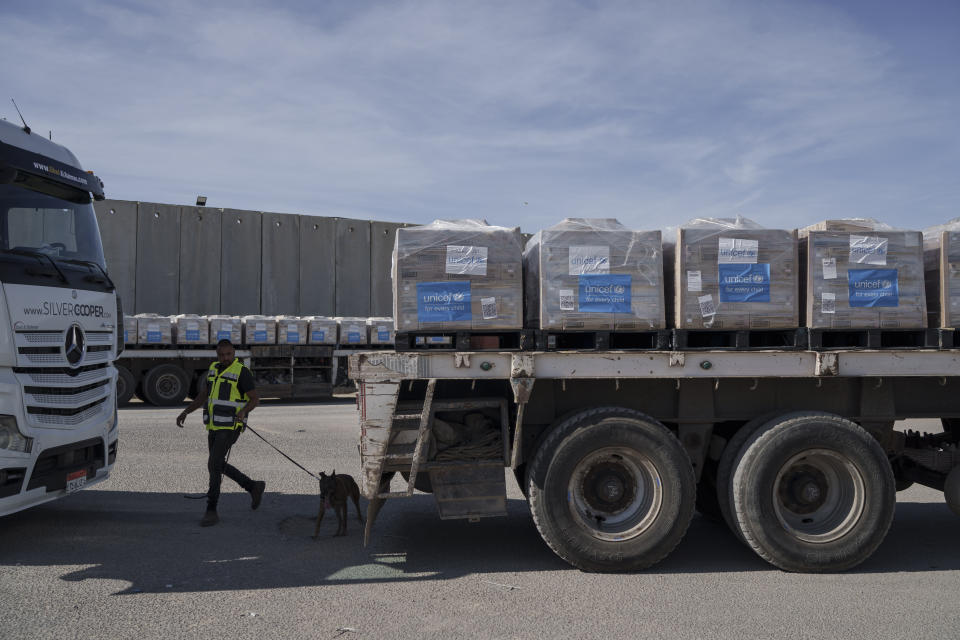 A border security guard inspects a truck carrying humanitarian aid to the Gaza Strip at the Kerem Shalom border crossing between Israel and Gaza, southern Israel, Monday, Jan. 8, 2024. (AP Photo/Leo Correa)