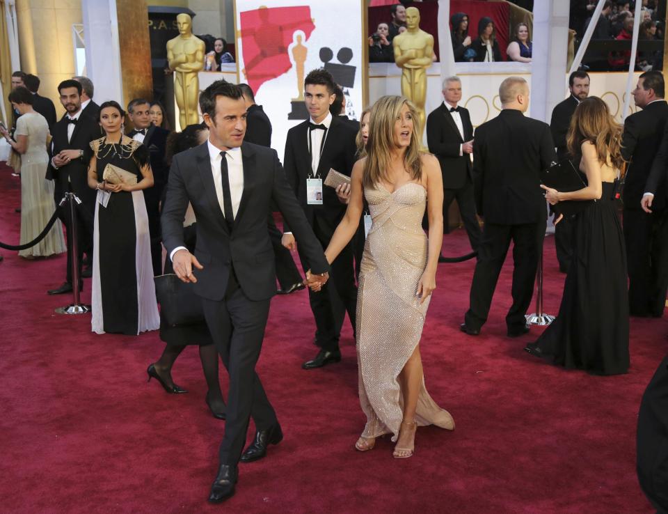 Actress Jennifer Aniston and actorJustin Theroux arrive at the 87th Academy Awards in Hollywood