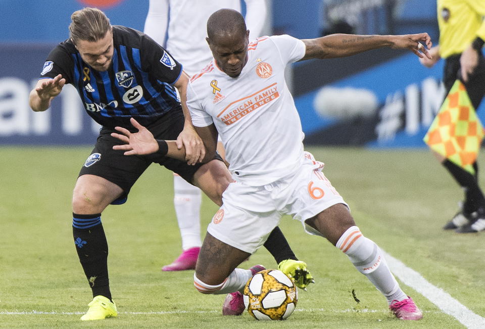 Atlanta United's Darlington Nagbe, right, challenges Montreal Impact's Samuel Piette during first half MLS soccer action in Montreal, Sunday, Sept. 29, 2019. (Graham Hughes/The Canadian Press via AP)