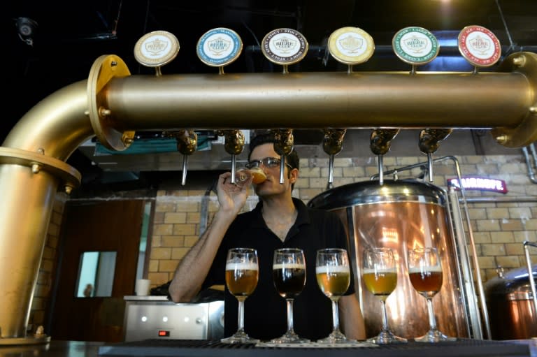 Head Brewer at The Biere Club, Rohit Jairam Parwani, tastes craft beer at the microbrewery in Bangalore