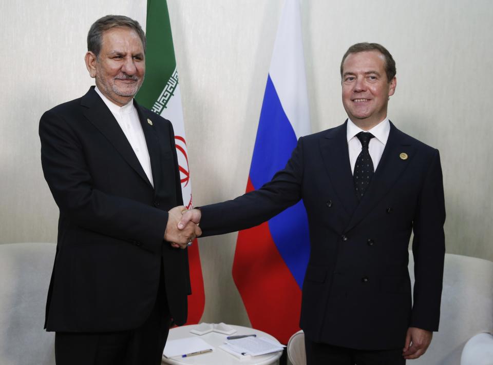 Russian Prime Minister Dmitry Medvedev, right, and Iranian Vice President Eshaq Jahangiri pose for a photo at the First Caspian Economic Forum in Turkmenbashi, Turkmenistan, Monday, Aug. 12, 2019. (Dmitry Astakhov, Sputnik, Government Pool Photo via AP)