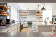 <p>The kitchen was part of the home’s upgrades. It has a large island and modern appliances. (Realtor.com) </p>