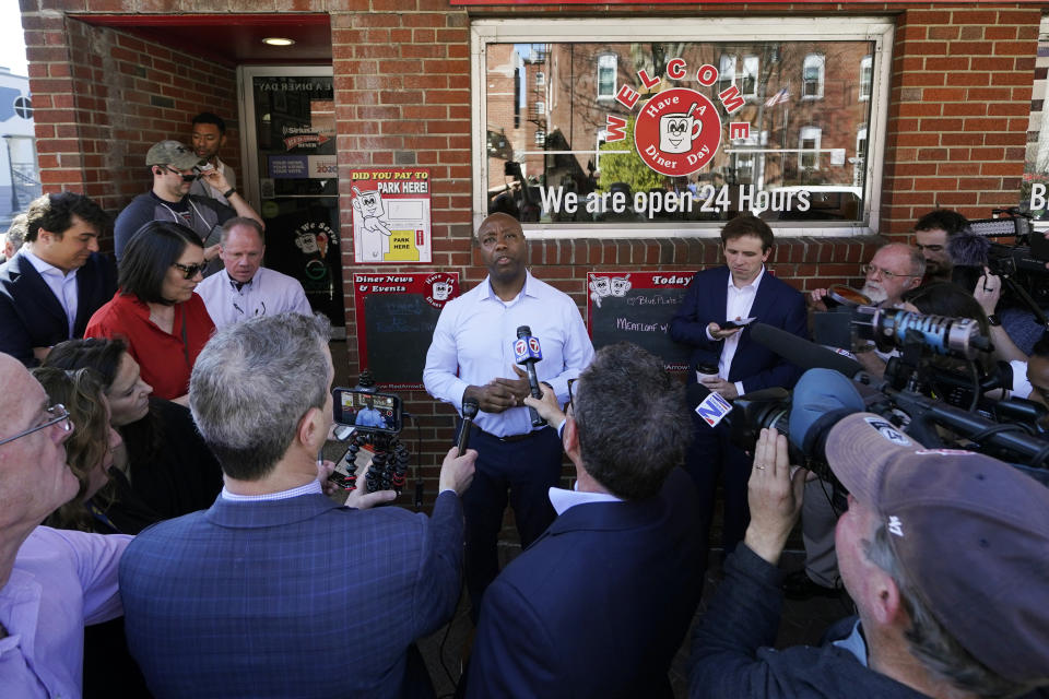 Sen. Tim Scott, R-S.C., talks with reporters during a visit to the Red Arrow Diner, Thursday, April 13, 2023, in Manchester, N.H. Scott on Wednesday launched an exploratory committee for a 2024 GOP presidential bid, a step that comes just shy of making his campaign official. (AP Photo/Charles Krupa)