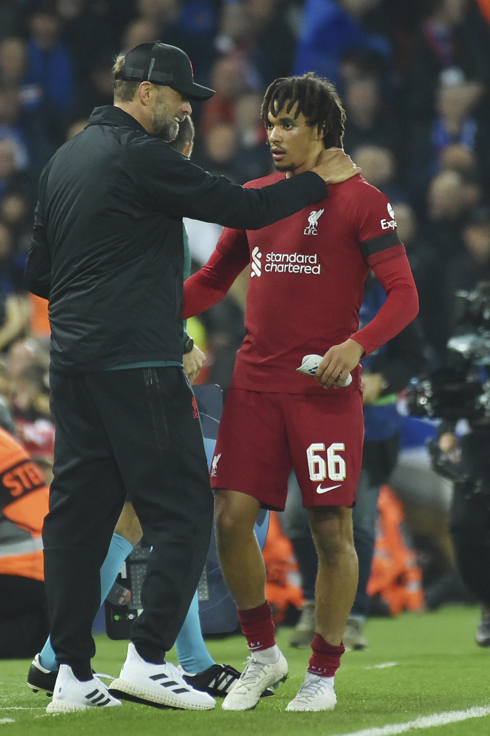 Liverpool's manager Jurgen Klopp, left, talks with Liverpool's Trent Alexander-Arnold after substitution during the Champions League Group A soccer match between Liverpool and Rangers at Anfield stadium in Liverpool, England, Tuesday Oct. 4, 2022. (AP Photo/Rui Vieira)